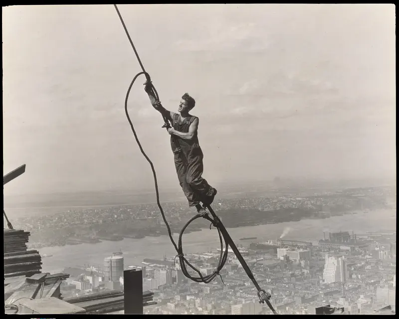 Icarus, High Above New York. Lewis Hine photographs a steelworker swinging on a cable a quarter mile above Manhattan as America's tallest skyscraper rises.