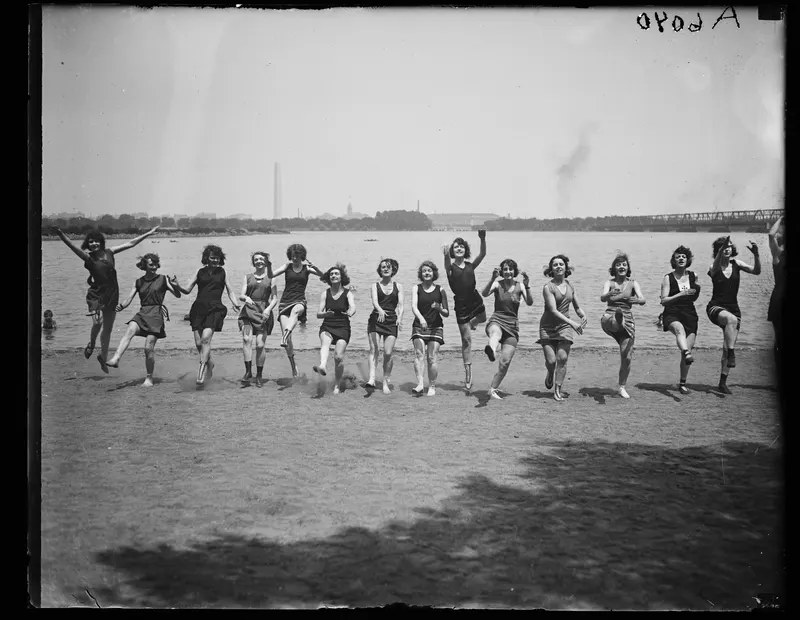 Bathing Beauties at the Monument, 1923 (Harris & Ewing). Dancers in bathing suits kick up their heels on the Tidal Basin beach, with the Washington Monument standing very still behind them.