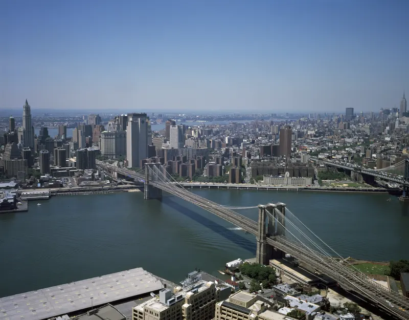 Brooklyn Bridge from the air toward Manhattan. When it opened in 1883 it was the longest suspension bridge in the world; P.T.