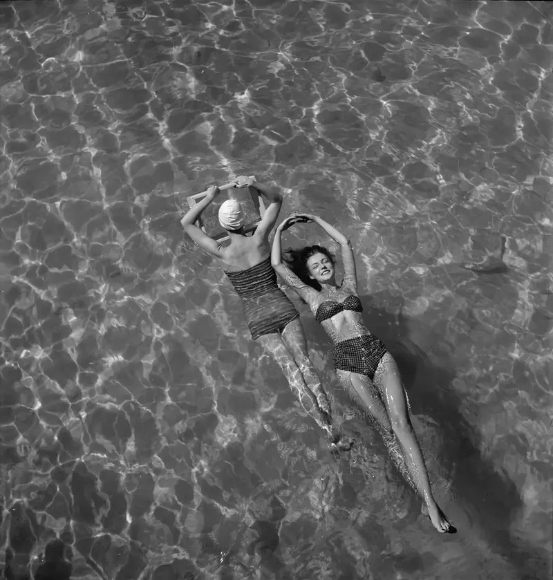 Floating Models, 1948 (Toni Frissell). Frissell had models float on their backs and shot straight down into the pool, decades before overhead pool shots became an Instagram cliche.