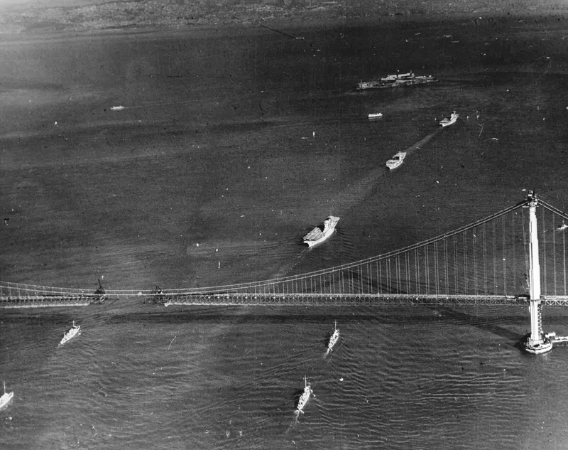 Navy carriers pass under the unfinished Golden Gate, 1936. Months before the bridge opened, the carriers USS Lexington and Saratoga steamed under its cables; the span was the world's longest suspension bridge until 1964.